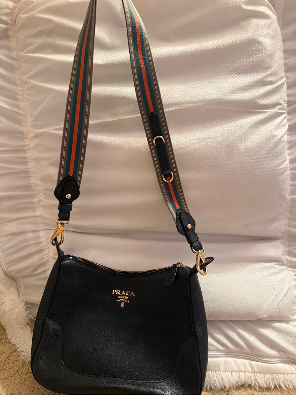 Prada Black Leather Handbag with Gold Zipper Detail